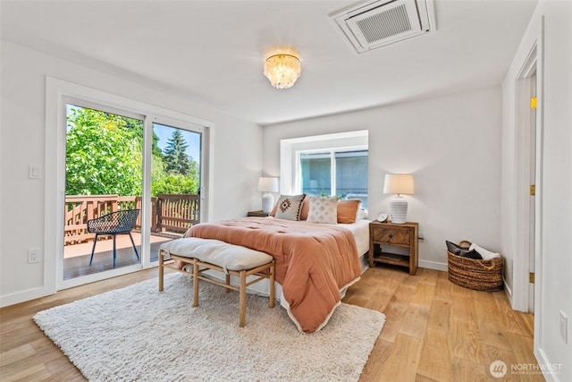 7006 20th Ave NE, Seattle, WA 98115 - bedroom with access to exterior and light wood-style floors