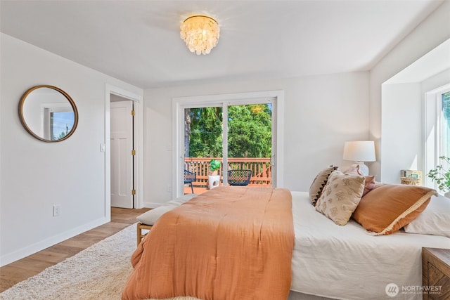 7006 20th Ave NE, Seattle, WA 98115 - bedroom featuring access to outside, wood finished floors, and multiple windows