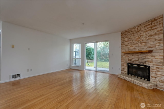 2969 142nd Pl SE # 8, Bellevue, WA 98007 - unfurnished living room featuring a stone fireplace and light wood finished floors