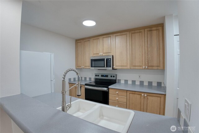 2969 142nd Pl SE # 8, Bellevue, WA 98007 - kitchen featuring stainless steel microwave, range with electric stovetop, freestanding refrigerator, and light brown cabinets