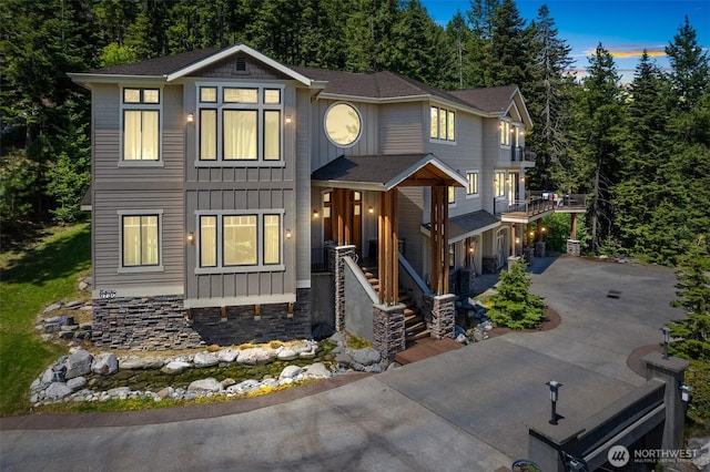 6730 Forest Ridge Dr, Wenatchee, WA 98801 - view of front of house with board and batten siding, concrete driveway, and a porch