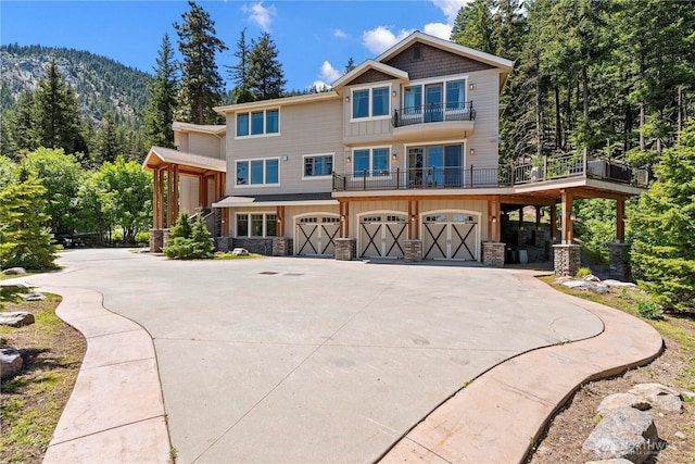 6730 Forest Ridge Dr, Wenatchee, WA 98801 - view of front of property with a balcony, board and batten siding, concrete driveway, stone siding, and a garage