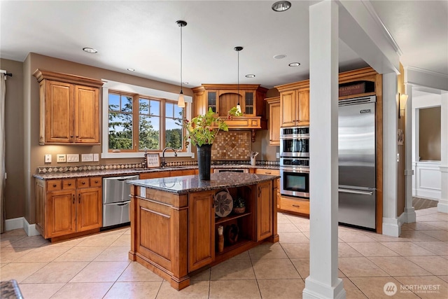 6730 Forest Ridge Dr, Wenatchee, WA 98801 - kitchen featuring appliances with stainless steel finishes, brown cabinetry, dark stone counters, open shelves, and recessed lighting