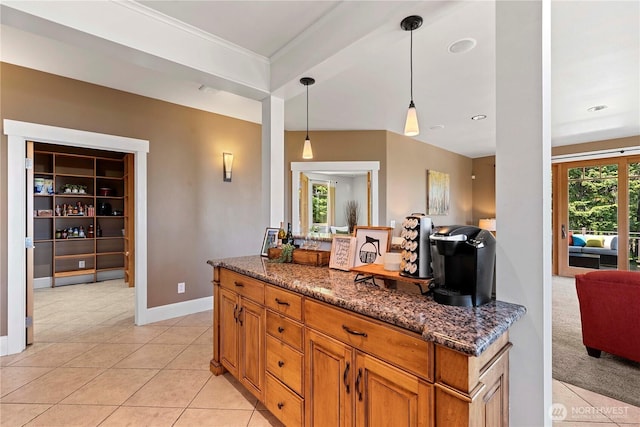 6730 Forest Ridge Dr, Wenatchee, WA 98801 - kitchen featuring light tile patterned flooring, open floor plan, dark stone counters, hanging light fixtures, and crown molding
