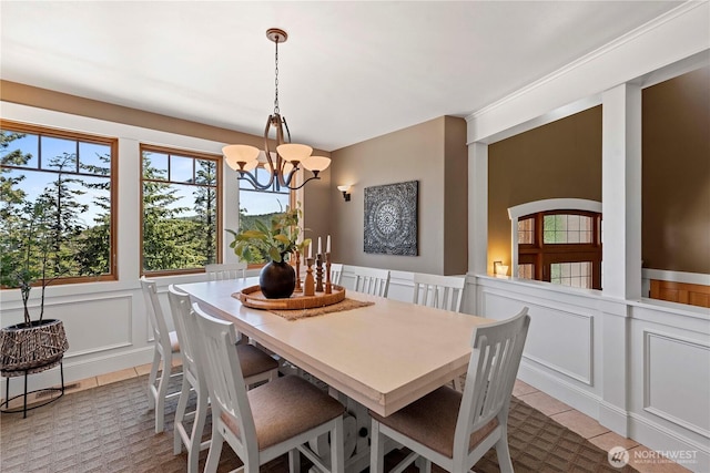 6730 Forest Ridge Dr, Wenatchee, WA 98801 - tiled dining area with a chandelier, a decorative wall, and wainscoting