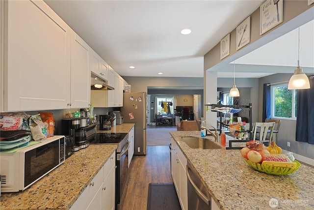 373 Adams Ave, Morton, WA 98356 - kitchen with appliances with stainless steel finishes, under cabinet range hood, white cabinets, light stone counters, and dark wood-type flooring