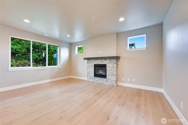 26517 NE 147th Pl Unit Sr 13, Duvall, WA 98019 - unfurnished living room featuring plenty of natural light, wood finished floors, a fireplace, and recessed lighting