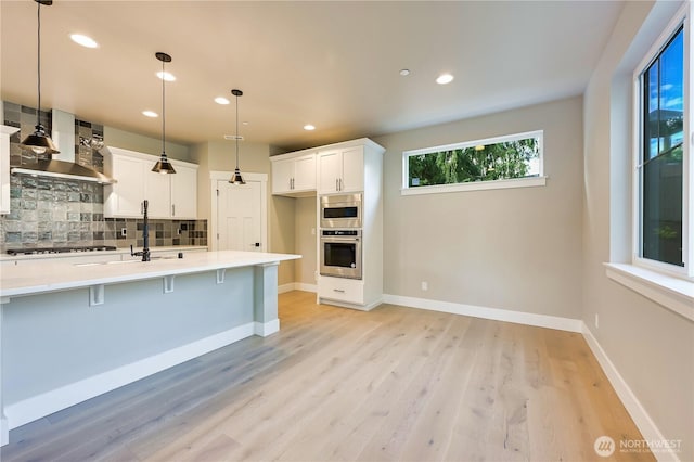 26517 NE 147th Pl Unit Sr 13, Duvall, WA 98019 - kitchen featuring stainless steel oven, tasteful backsplash, gas stovetop, light countertops, and light wood-style floors