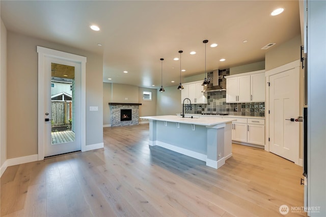 26517 NE 147th Pl Unit Sr 13, Duvall, WA 98019 - kitchen with open floor plan, tasteful backsplash, white cabinetry, light wood-style floors, and recessed lighting