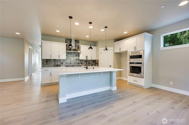 26517 NE 147th Pl Unit Sr 13, Duvall, WA 98019 - kitchen featuring stainless steel appliances, wall chimney exhaust hood, recessed lighting, decorative backsplash, and white cabinetry