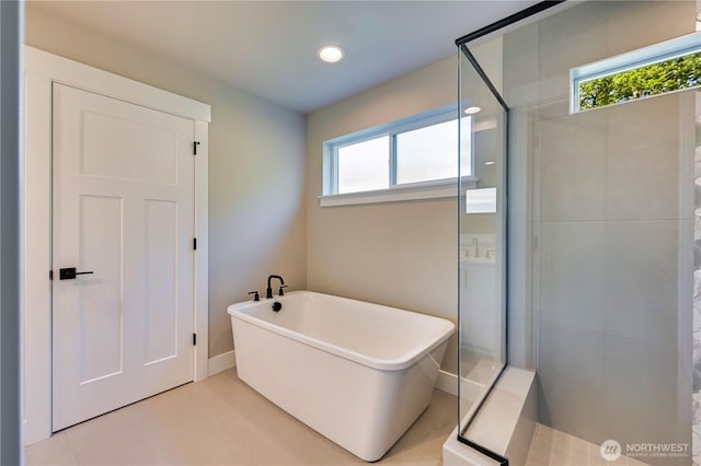 26517 NE 147th Pl Unit Sr 13, Duvall, WA 98019 - bathroom with a stall shower, plenty of natural light, a freestanding bath, tile patterned flooring, and recessed lighting