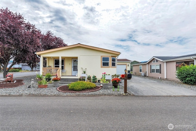 523 N 7th Ave, Sequim, WA 98382 - view of front of house featuring covered porch, driveway, and a garage