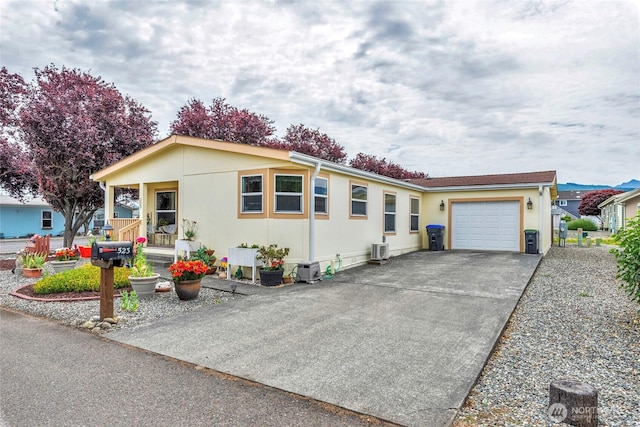 523 N 7th Ave, Sequim, WA 98382 - view of front facade with an attached garage, concrete driveway, and stucco siding