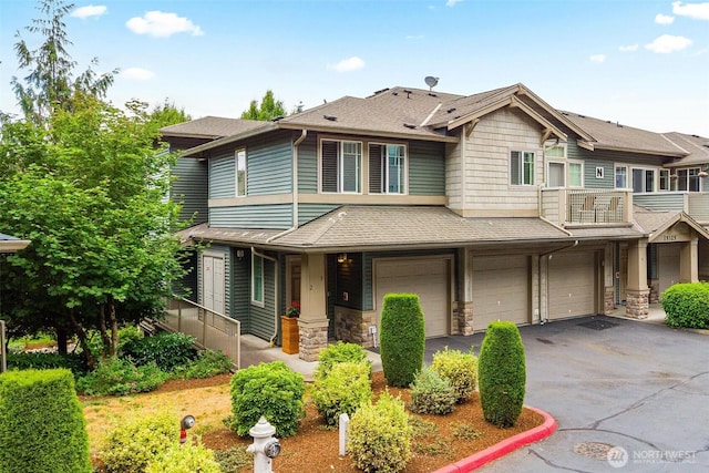 15325 SE 155th Pl Unit N-2, Renton, WA 98058 - view of property with an attached garage, driveway, stone siding, and roof with shingles
