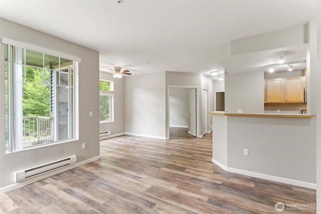 15325 SE 155th Pl Unit N-2, Renton, WA 98058 - unfurnished living room with a baseboard heating unit, wood finished floors, and a ceiling fan
