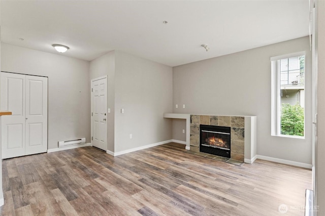 15325 SE 155th Pl Unit N-2, Renton, WA 98058 - unfurnished living room with a baseboard heating unit, wood finished floors, and a tile fireplace