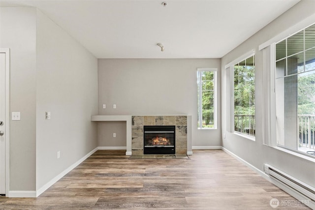 15325 SE 155th Pl Unit N-2, Renton, WA 98058 - unfurnished living room with baseboard heating, wood finished floors, and a fireplace