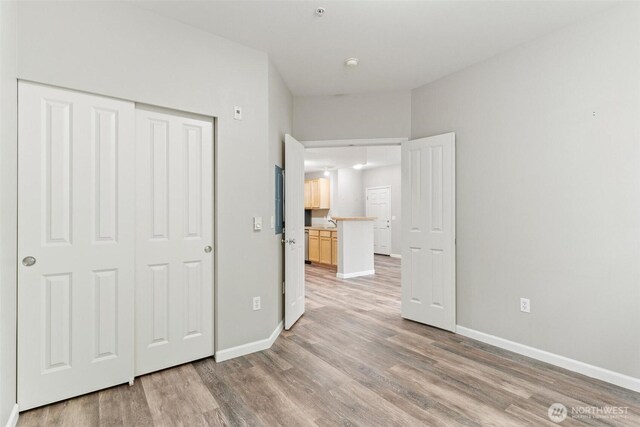 15325 SE 155th Pl Unit N-2, Renton, WA 98058 - unfurnished bedroom featuring light wood finished floors and a closet