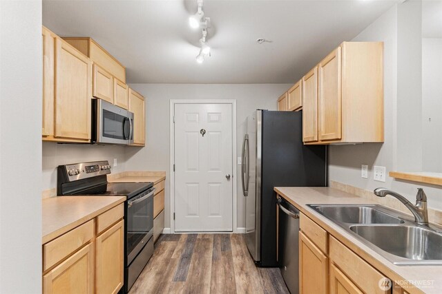 15325 SE 155th Pl Unit N-2, Renton, WA 98058 - kitchen featuring appliances with stainless steel finishes, light brown cabinetry, dark wood-type flooring, and light countertops