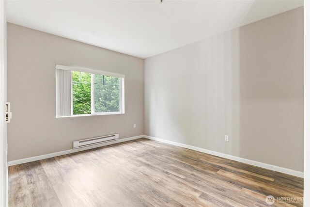 15325 SE 155th Pl Unit N-2, Renton, WA 98058 - unfurnished room featuring a baseboard radiator and wood finished floors
