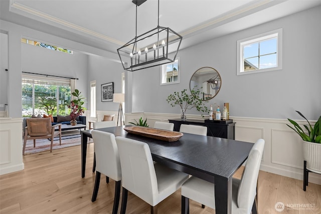 8122 NE 189th Pl, Kenmore, WA 98028 - dining space featuring wainscoting, a chandelier, healthy amount of natural light, ornamental molding, and light wood-type flooring