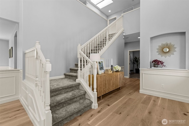 8122 NE 189th Pl, Kenmore, WA 98028 - staircase featuring a towering ceiling, wood finished floors, and recessed lighting