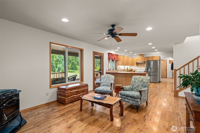 25901 NE 412th Cir, Amboy, WA 98601 - living room featuring a wood stove, light wood-type flooring, stairs, a ceiling fan, and recessed lighting