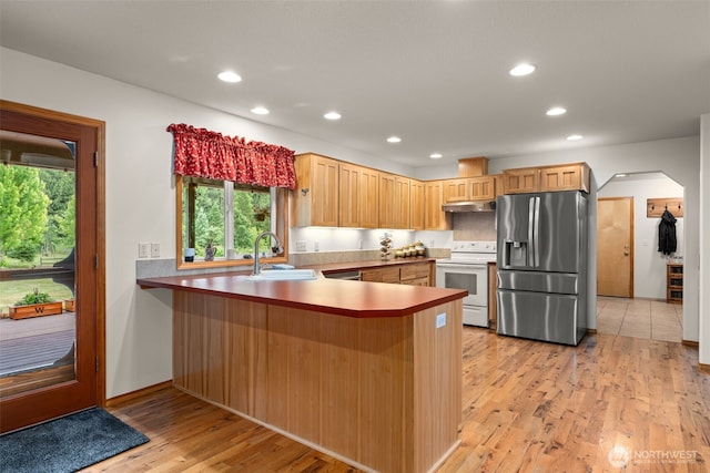 25901 NE 412th Cir, Amboy, WA 98601 - kitchen with stainless steel refrigerator with ice dispenser, white range with electric cooktop, a peninsula, recessed lighting, and light wood finished floors