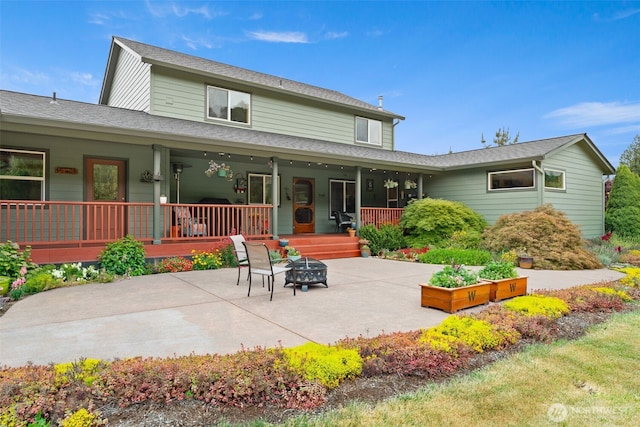 25901 NE 412th Cir, Amboy, WA 98601 - rear view of property with a patio area and a fire pit