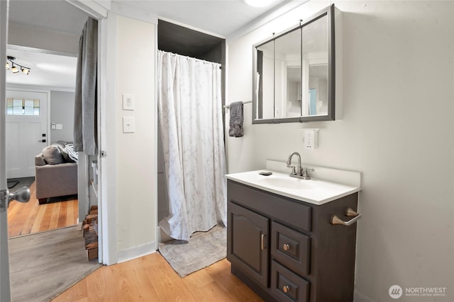 1580 134th Ln, Long Beach, WA 98631 - full bathroom with vanity, wood finished floors, and a shower with shower curtain