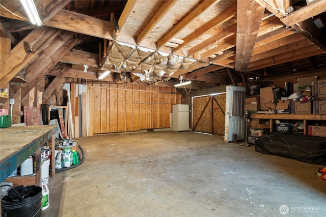 1580 134th Ln, Long Beach, WA 98631 - garage with freestanding refrigerator and a workshop area