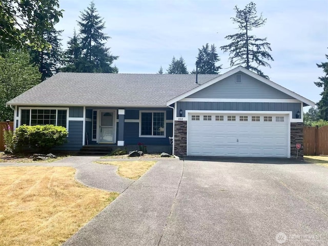 2218 143rd Street Ct S, Spanaway, WA 98387 - ranch-style house featuring driveway, stone siding, an attached garage, roof with shingles, and board and batten siding