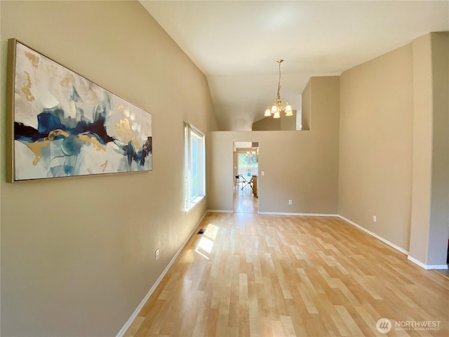 2218 143rd Street Ct S, Spanaway, WA 98387 - unfurnished dining area with a chandelier, light wood finished floors, and lofted ceiling