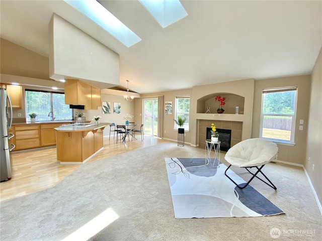 2218 143rd Street Ct S, Spanaway, WA 98387 - living room featuring light carpet, lofted ceiling, healthy amount of natural light, and a tile fireplace