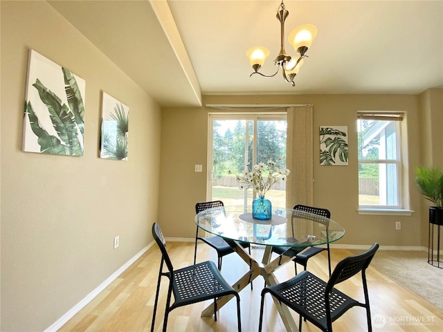 2218 143rd Street Ct S, Spanaway, WA 98387 - dining space featuring healthy amount of natural light, a chandelier, and light wood-style floors