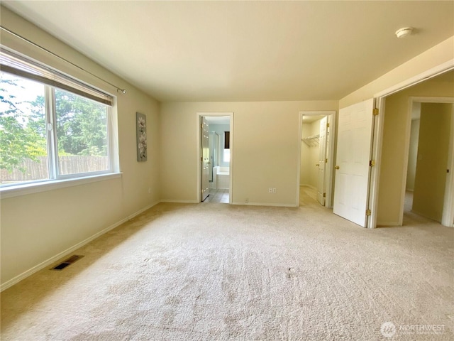 2218 143rd Street Ct S, Spanaway, WA 98387 - unfurnished bedroom with light carpet, a walk in closet, connected bathroom, and a closet