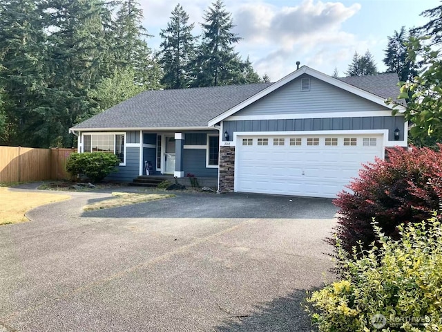 2218 143rd Street Ct S, Spanaway, WA 98387 - ranch-style home with driveway, stone siding, an attached garage, a shingled roof, and board and batten siding