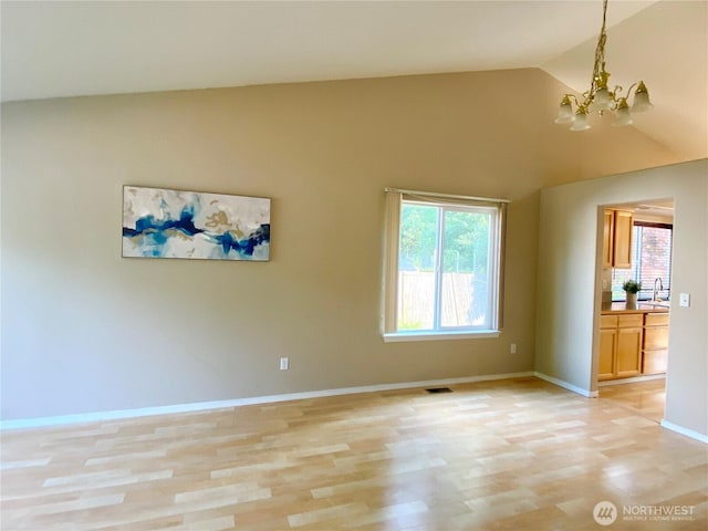 2218 143rd Street Ct S, Spanaway, WA 98387 - spare room with a chandelier, light wood finished floors, and high vaulted ceiling