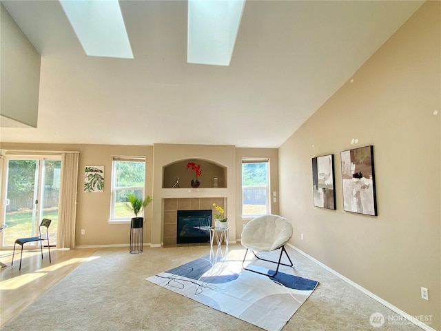 2218 143rd Street Ct S, Spanaway, WA 98387 - living area with light colored carpet, lofted ceiling, plenty of natural light, a tiled fireplace, and a skylight