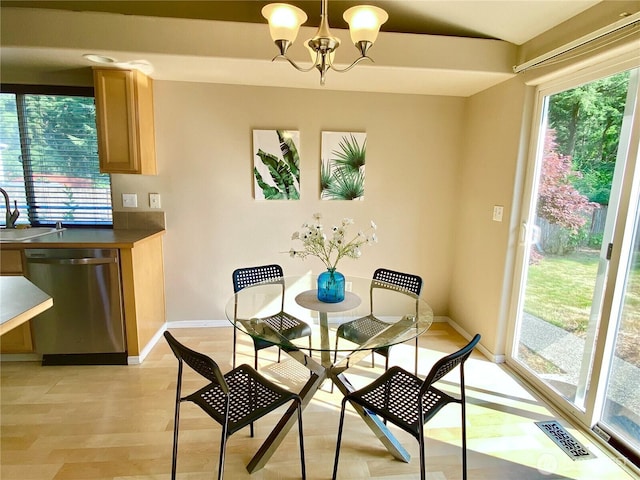 2218 143rd Street Ct S, Spanaway, WA 98387 - dining room featuring healthy amount of natural light, a chandelier, and light wood-style floors