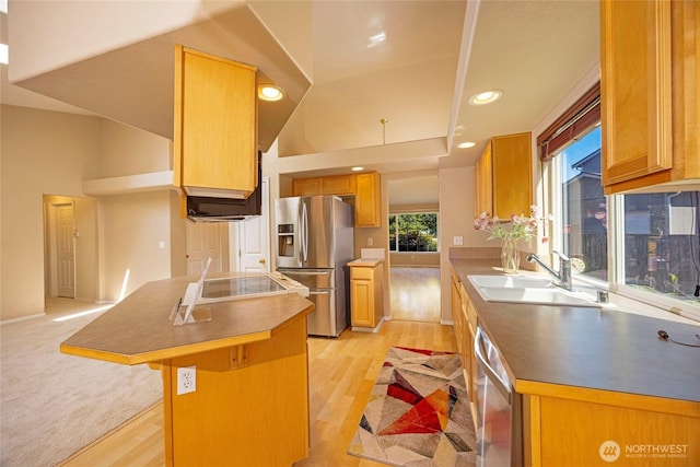 2218 143rd Street Ct S, Spanaway, WA 98387 - kitchen featuring appliances with stainless steel finishes, healthy amount of natural light, light wood-style flooring, a kitchen bar, and recessed lighting