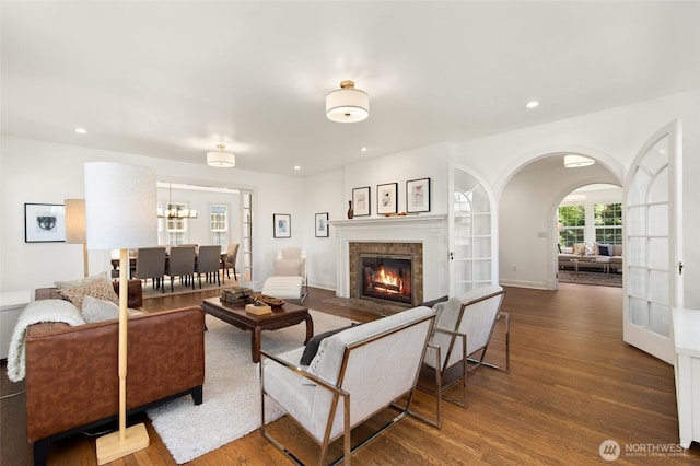 817 E Shelby St, Seattle, WA 98102 - living area with wood finished floors, a fireplace with flush hearth, recessed lighting, arched walkways, and a chandelier