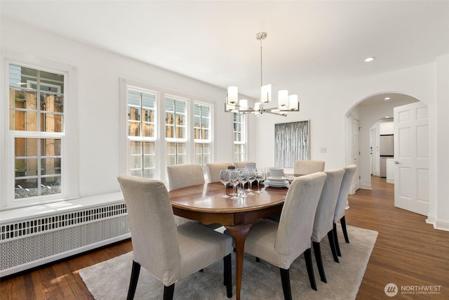817 E Shelby St, Seattle, WA 98102 - dining area with radiator heating unit, a chandelier, arched walkways, wood finished floors, and recessed lighting