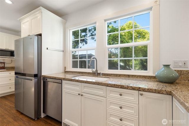 817 E Shelby St, Seattle, WA 98102 - kitchen with appliances with stainless steel finishes, white cabinets, light stone countertops, and dark wood-style floors