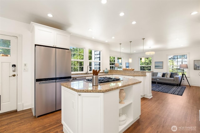 817 E Shelby St, Seattle, WA 98102 - kitchen featuring appliances with stainless steel finishes, dark wood-type flooring, a kitchen island, open floor plan, and recessed lighting