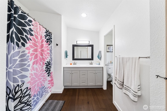 32205 71st Ave S, Roy, WA 98580 - bathroom featuring wood finished floors, double vanity, lofted ceiling, and recessed lighting