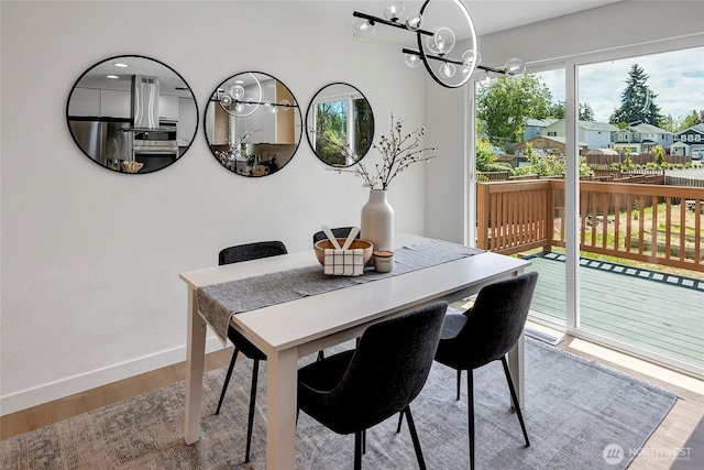 320 178th Pl SW, Bothell, WA 98012 - dining area with wood finished floors, a chandelier, and a residential view