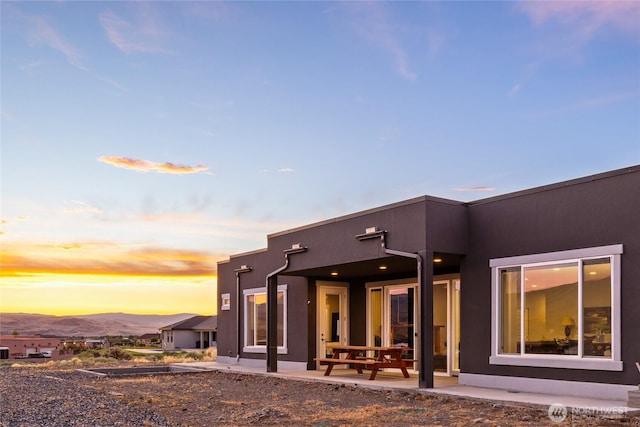 101 Wren Loop SW, Mattawa, WA 99349 - back of property at dusk featuring stucco siding and a patio
