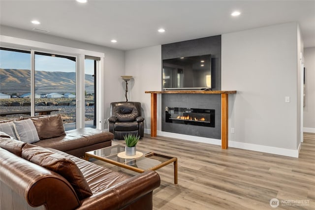 101 Wren Loop SW, Mattawa, WA 99349 - living room featuring light wood-type flooring, a fireplace, and recessed lighting