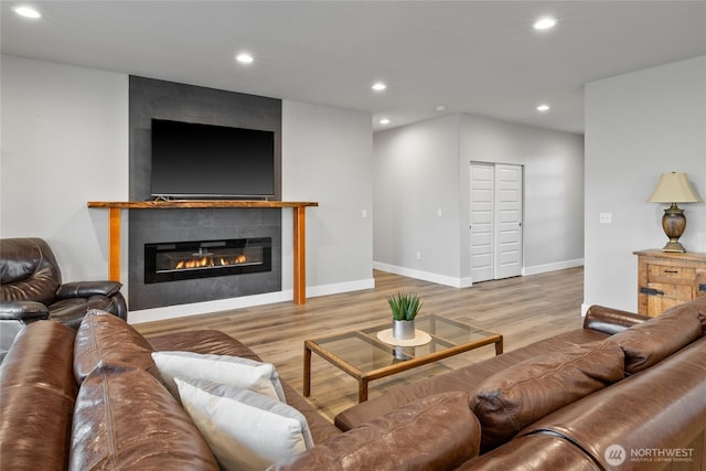 101 Wren Loop SW, Mattawa, WA 99349 - living area with wood finished floors, a tiled fireplace, and recessed lighting